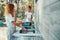 Teenager girl washing up the dishes pots and plates with help her younger sister in the outdoor kitchen during vacations on