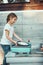 Teenager girl washing up the dishes pots and plates with help her younger sister in the outdoor kitchen during vacations on