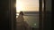 Teenager girl watching sunrise from balcony on cruise ship