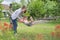 Teenager girls and child having fun in garden on hammock