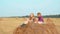 Teenager girls sitting on haystack summer day