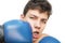 A teenager got a kick on his face with a boxing gloves on a white background. Braces are installed on his teeth