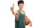 Teenager in green jersey with basketball and thumb up