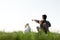 Teenager on green lawn with small white dog