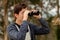 Teenager guy looking with binoculars