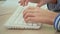 Teenager hands typing on white keyboard, e-learning student