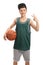 Teenager holding a basketball and making a victory gesture