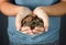 A Teenager Holding a Handful of Coins