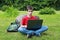 Teenager with a laptop in the park