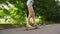 Teenager learning to ride skateboard in countryside