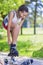 Teenager Lifestyle Concepts. African American Teenage Girl Puts On Roller Skates in Park Outdoors