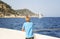 Teenager looks at the sea from the deck of a boat