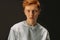 Teenager male with red hair posing at camera isolated