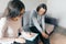 Teenager patient girl talking with professional psychotherapist in office.