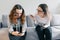 Teenager patient girl talking with professional psychotherapist in office. Girl looks into her phone ignores a psychologist.