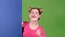 Teenager peeks out from behind a blue board and shows a thumbs up. Green screen. Slow motion