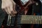 Teenager plays the electric guitar. The fingers of a young bassist are pulling bass strings. Musical theme. Close-up