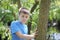 A teenager poses for a photographer while walking in the park. Thoughtful look.