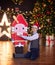 Teenager in a red cap in the studio for the new year with a nutcracker doll