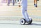 Teenager rides a gyroboard on the square