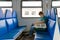 A teenager rides a train with pet carrier