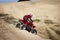 Teenager Riding ATV in Sand Dunes