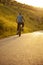 Teenager riding a bicycle on the road summer sunlit