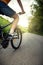 Teenager riding a bicycle on the road summer sunlit