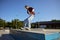 Teenager rollerskater balancing on pedestal performing extremely ride tricks