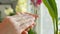 Teenager is rubbing hands applying sun protection cream to arm finger closeup