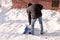 A teenager shoveling snow in his yard. The concept of a snowy winter