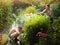 Teenager siblings brother and sister spray each other with water hose