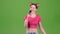 Teenager sings into the microphone. Green screen. Slow motion