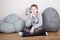 Teenager sits on laminate floor with a stone ax