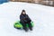 Teenager sitting on green tubing