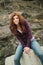 Teenager sitting on rock