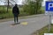 Teenager on skateboard on a roller blade  asphalt track with yellow icons of roller skate.