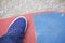 A teenager with a skateboard. Sits on a skateboard. View from above.