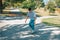 Teenager with skateboard skating on the street