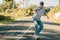 Teenager with skateboard skating on the street