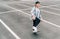 Teenager skateboarder boy with a skateboard on asphalt playground doing tricks. Youth generation outdoor Freetime spending concept