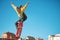 A teenager skateboarder does an ollie trick in a skatepark on the outskirts of the city