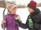 Teenager skier girl with skies having drink tea brake