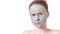 Teenager skincare concept. Young teen girl with dried clay facial mask making funny face, isolated