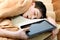 Teenager sleeps with Tablet