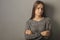 Teenager sorrow,sad depressed teen girl stands with her arms crossed, looking down