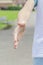 A teenager in sportswear extends his hand for a handshake and invites for a jog in the park