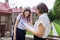 Teenager student girl talking with teacher, woman with clipboard