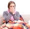 Teenager suffering from cold sitting on coach