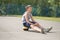 A teenager in a T-shirt is sitting on a ball resting